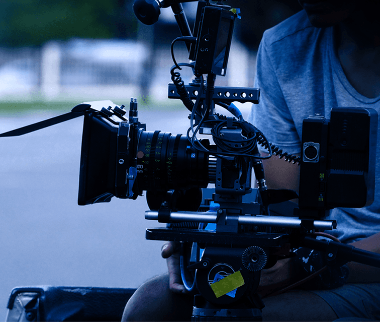 Cinematographer filming on set at night